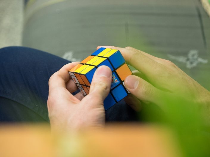 A man's hands playing with Rubik's Cube