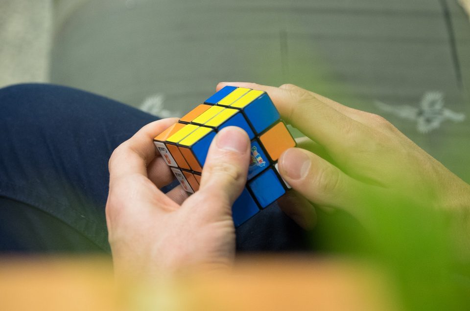 A man's hands playing with Rubik's Cube
